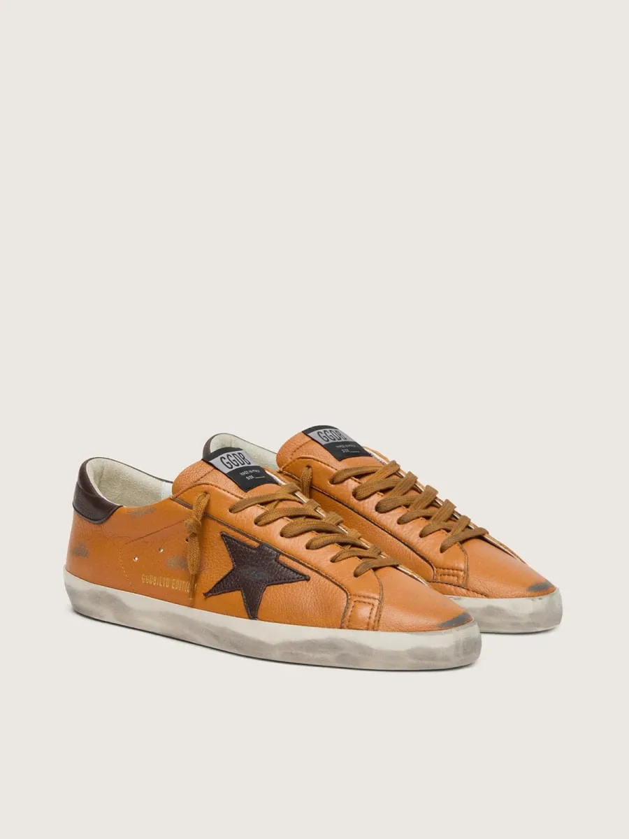 Super-Star LTD uomo in pelle arancione con stella marrone