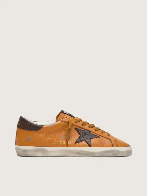 Super-Star LTD uomo in pelle arancione con stella marrone